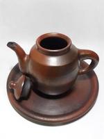 Clay teapot isolated on grey  background. photo