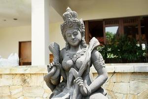 stone statue of hindu god under noon sun photo