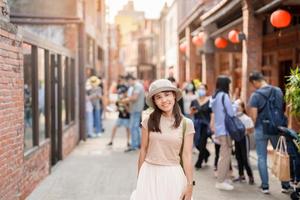 woman traveler visiting in Taiwan, Tourist with backpack and hat sightseeing in Bopiliao Historic Block, landmark and popular attractions in Taipei city. Asia Travel photo