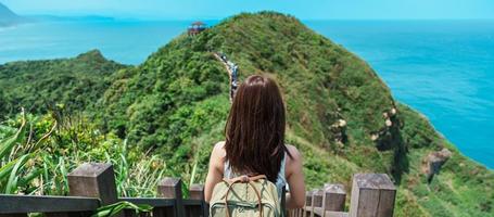 woman traveler visiting in Taiwan, Tourist with backpack sightseeing in Bitou Cape Hiking Trail, New Taipei City. landmark and popular attractions near Taipei. Asia Travel concept photo