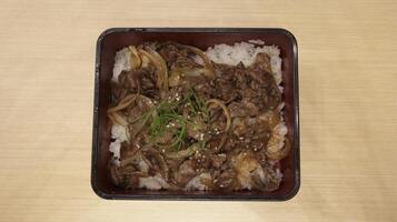 Japanese food yakiniku grilled meat cuisine in the box with rice. photo