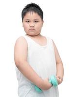 handsome obese boy is doing exercises with dumbbells photo