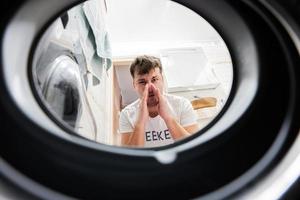 Man view from washing machine inside. photo