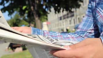 Young reading newspaper video