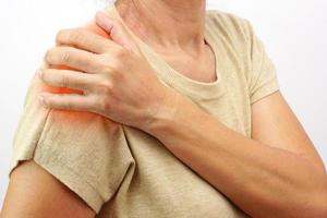 Woman suffering from upper arm. Healthcare and office syndrome concept. photo