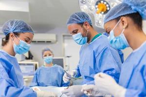 Doctor and assistant nurse operating for help patient from dangerous emergency case .Surgical instruments on the sterile table in the emergency operation room in the hospital.Health care and Medical photo