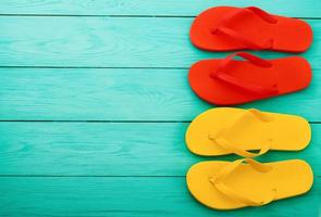 flip flops on blue wooden background with copy space. Top view. Mock up. Summer shoes sandals. Slippers photo