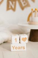 Wooden cubes, a perpetual calendar with one year. Photo zone of the celebration of the first year of the baby with a copy space