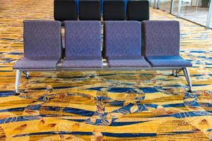 A row of chair at the lobby of airport photo
