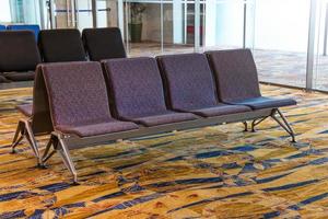 A row of chair at the lobby of airport photo