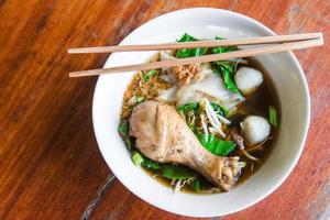 Chicken noodle on wooden table photo