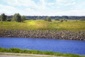 Beautiful nature with river meadows and blue sky. photo