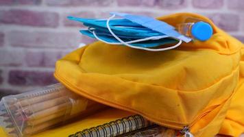 back to school concept with yellow backpack and school suppliers on table video