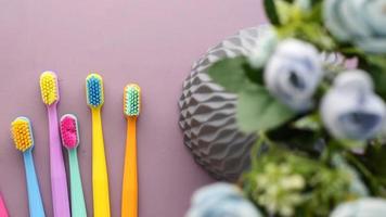 colorful toothbrushes on purple color background video