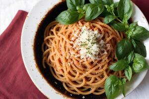 Spaghetti pasta with parmesan cheese and parsley on a plate. photo