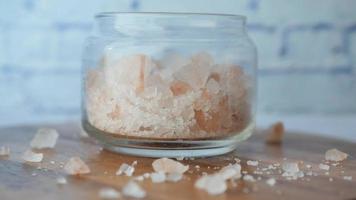 close up of pink rock salt in a bowl on table video