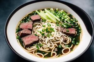 Japanese ramen noodle soup with beef and green onion in bowl. Beef soup. photo