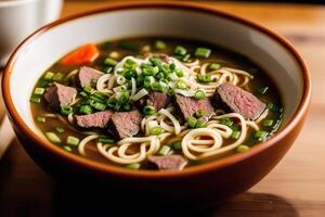 Japanese ramen noodle soup with beef and green onion in bowl. Beef soup. photo