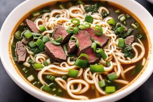 Japanese ramen noodle soup with beef and green onion in bowl. Beef soup. photo