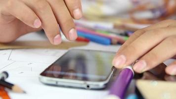 Architecture student using phone to draw, student checking calculations and project from phone for drawing project, selective focus video