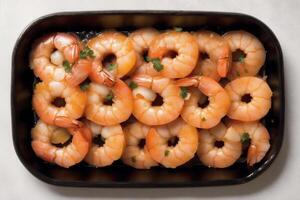 Shrimps with parsley and lemon on a white plate. photo