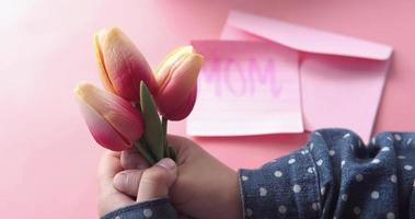 Mother day concept of child hand holding tulip flower video