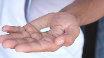 Close up of man hand holding pills with copy space video