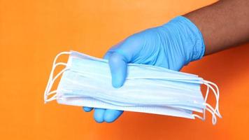 a man with latex gloves holding a mask video