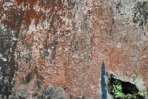 photo of red wall texture with cement on the wall