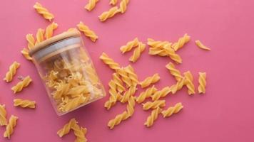 Fusilli spaghetti pattern in a jar on table , video