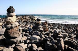 Rock pyramids on the beach photo