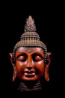 Buddha sculpture on black background photo