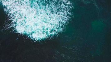 Top view of waves and two surfers on the surface of the Atlantic Ocean off the coast of Tenerife, Canary Islands, Spain video