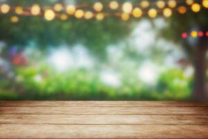 Empty wooden table with party in garden background blurred photo