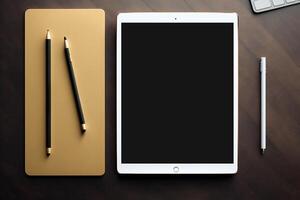 A tablet and a pen sit on top of a wooden desk. photo