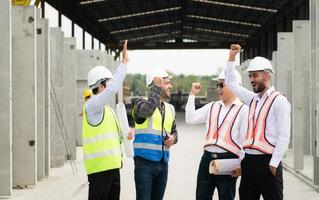 Construction engineers, architects, and foremen form a group. Participate in a meeting to plan new construction projects. Cheers to express happiness that the event was successfully accomplished. photo
