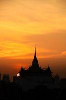 At a temple in the central of Bangkok Thailand, The morning sun will gradually move up to stand out at the end of this temple pagoda. This miracle happens only twice a year. photo