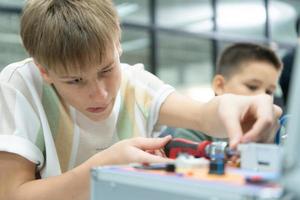 Youngsters utilizing the hand robot technology are having fun learning the electronic circuit board and hand robot controller of robot technology, which is one of the STEM courses. photo