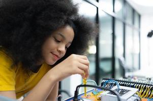 Youngsters utilizing the hand robot technology are having fun learning the electronic circuit board of hand robot technology, which is one of the STEM courses. photo