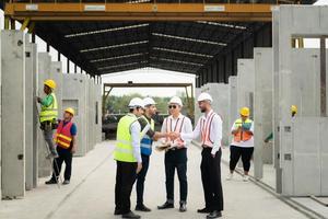 Architects a visit to the construction site. Ready to talk the progress of construction projects in the construction area with construction supervision engineers. photo