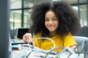 Children using the hand robot technology and having fun Learning the electronic circuit board of hand robot technology, which is one of the STEM courses. photo