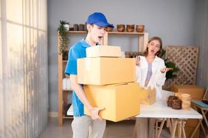 The delivery man brings the goods that the customer purchased and delivers them to the customer's home. photo