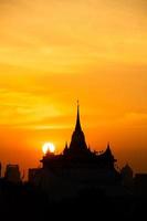 At a temple in the central of Bangkok Thailand, The morning sun will gradually move up to stand out at the end of this temple pagoda. This miracle happens only twice a year. photo