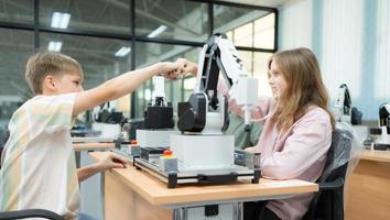 Children using the hand robot technology and having fun Learning, Students are studying technology, which is one of the STEM courses. photo