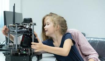 Children using the hand robot technology and having fun Learning the electronic circuit board of hand robot technology, which is one of the STEM courses. photo