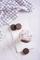 Homemade smoothie with cream and whipped chocolate chip cookies in a glass top and vertical view photo