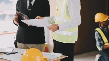 architect man working with laptop and blueprints,engineer inspection in workplace for architectural plan,sketching a construction project ,selective focus,Business concept vintage color video