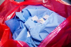 Biological risk waste disposed of in the red trash bag at a operating room in a hospital photo