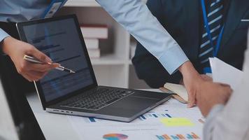 Financial analysts analyze business financial reports on a digital tablet planning investment project during a discussion at a meeting of corporate showing the results of their successful teamwork. video