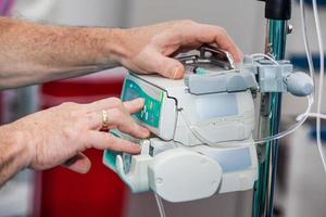 Anesthetist at a operating room setting the anesthesia machine photo